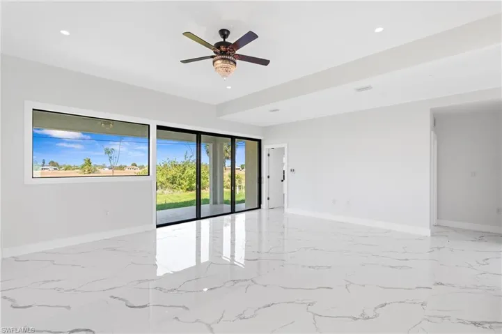 Empty room with ceiling fan and recessed lighting
