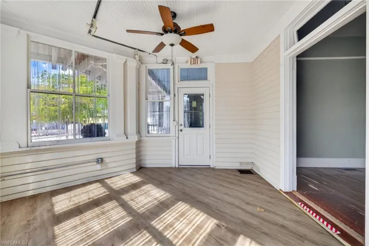 Unfurnished sunroom with a ceiling fan