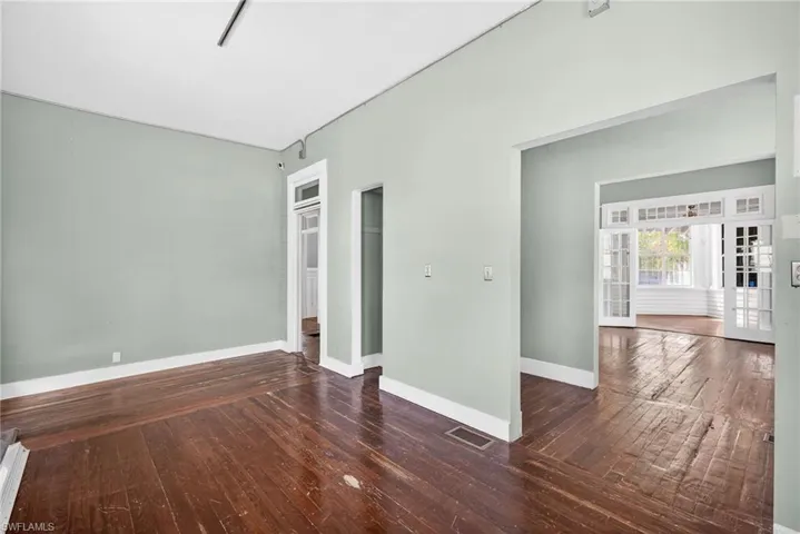 Empty room with dark wood-type flooring