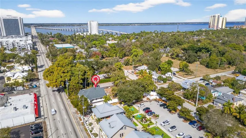 Aerial view of property and surrounding area featuring a large body of water and a notable bridge