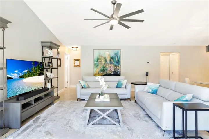 Living room with vaulted ceiling and ceiling fan