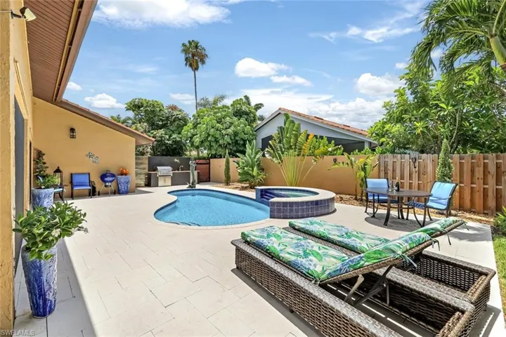 View of swimming pool with an in ground hot tub, exterior kitchen, and a patio