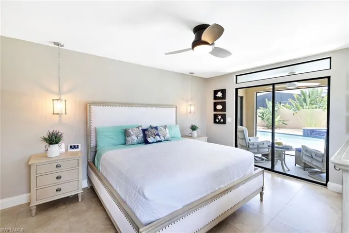 Bedroom featuring ceiling fan, access to exterior, and light tile patterned floors