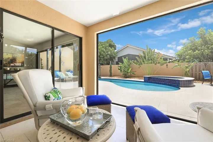 View of swimming pool with an in ground hot tub