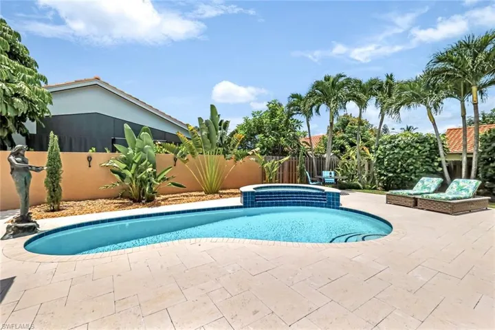 View of swimming pool with a patio and an in ground hot tub