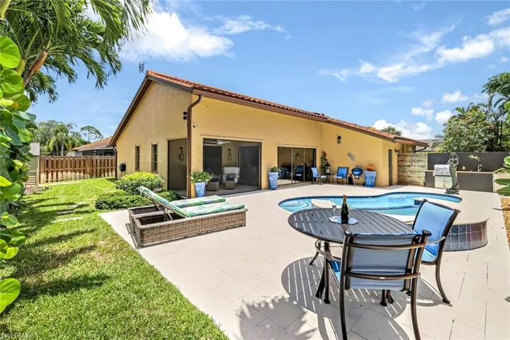 View of swimming pool featuring exterior kitchen and a patio area