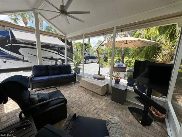 Sunroom with a wealth of natural light, lofted ceiling, and ceiling fan