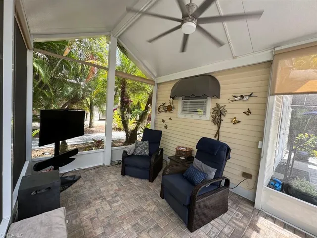 Sunroom / solarium featuring ceiling fan and lofted ceiling