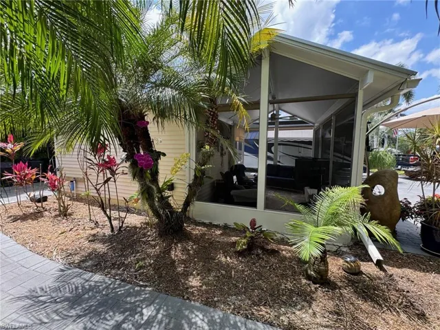View of side of property with a sunroom