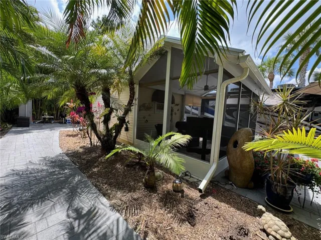 View of property exterior with a sunroom