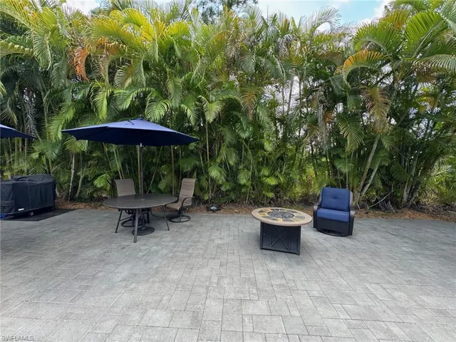 View of patio featuring a fire pit and a grill