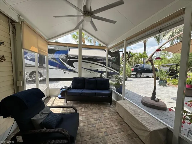 View of patio featuring ceiling fan and an outdoor living space