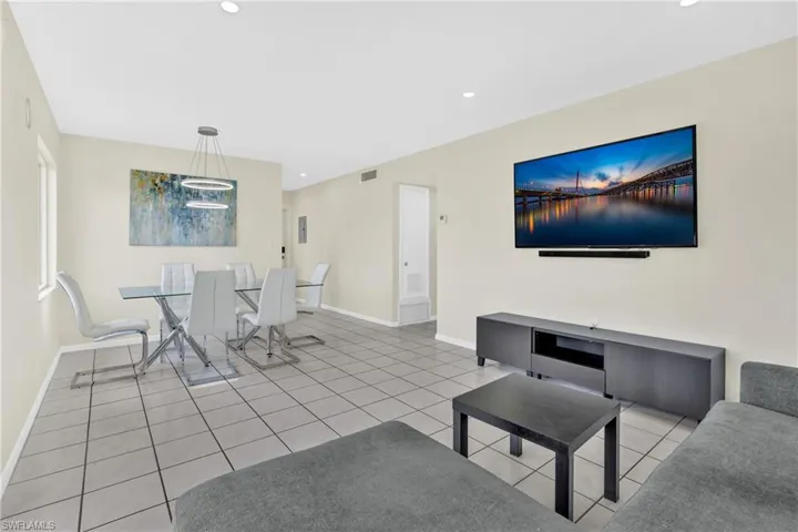 Living area featuring recessed lighting and light tile patterned flooring