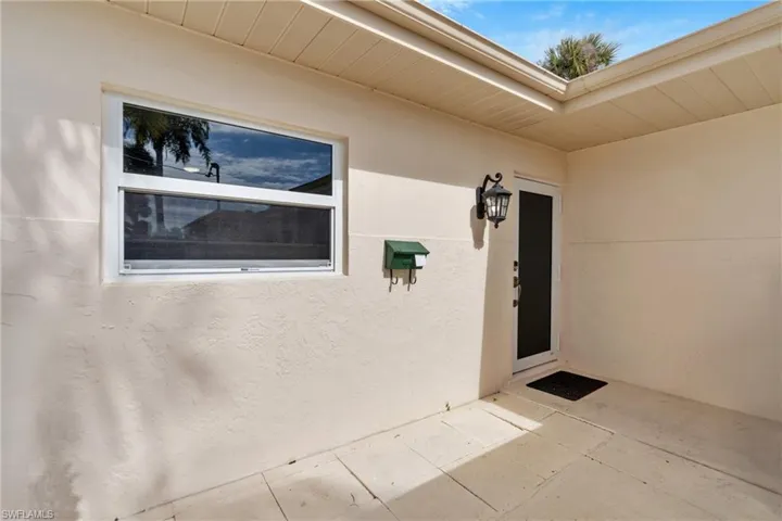 View of exterior entry featuring stucco siding
