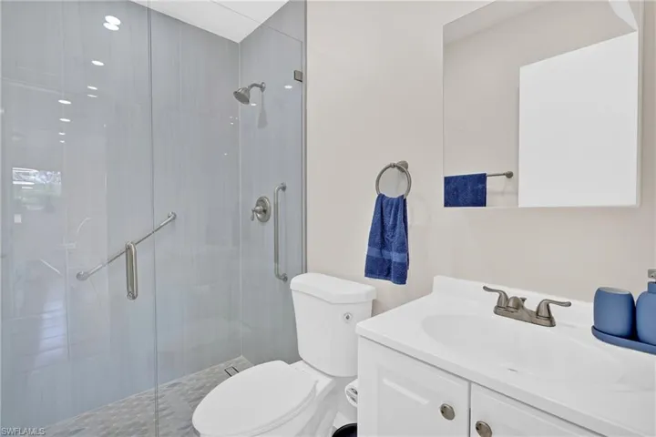 Full bathroom featuring vanity and a shower stall