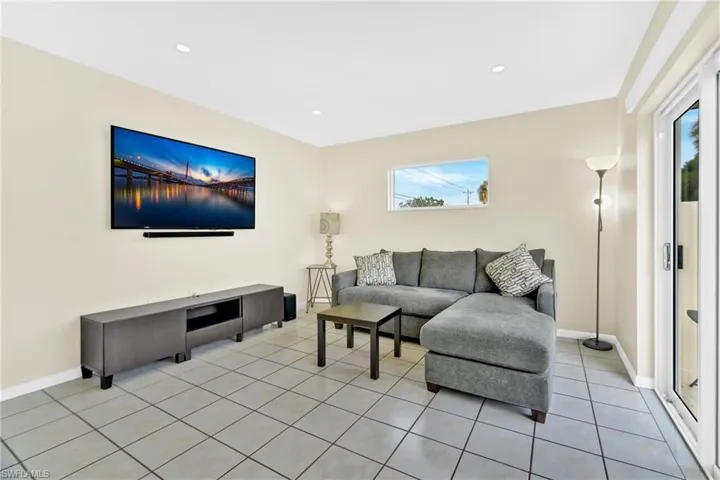 Living area featuring light tile patterned floors and recessed lighting