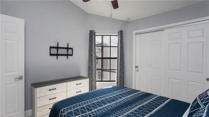 Bedroom with ceiling fan and a closet