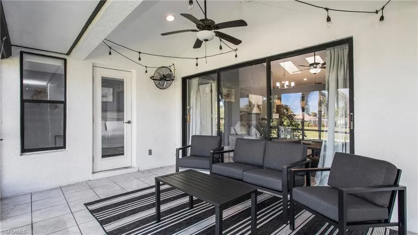 View of lanai with outdoor lounge area and ceiling fan