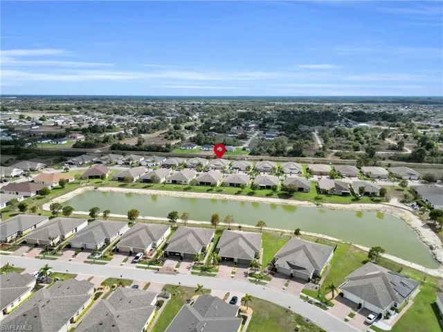 Aerial perspective of suburban area featuring a large body of water