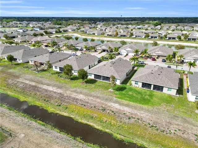 Aerial view of residential area featuring a large body of water