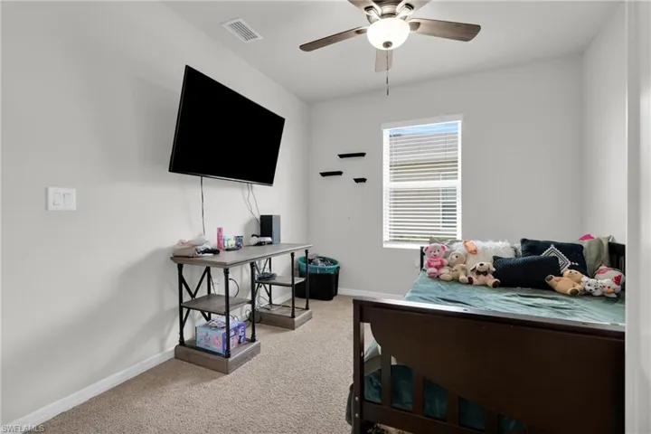 Bedroom featuring light colored carpet and ceiling fan