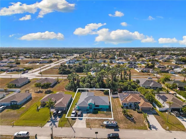 Aerial perspective of suburban area featuring property boundaries highlighted