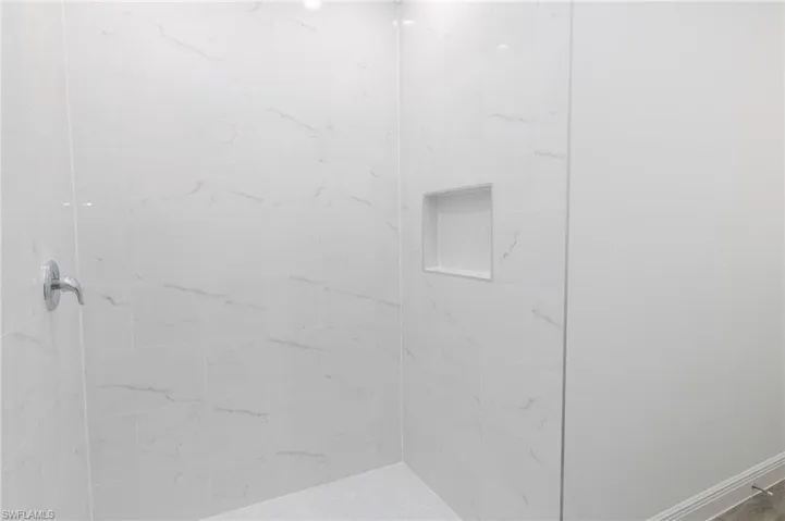 Master bathroom with toilet, vinyl floors, vanity, and a shower