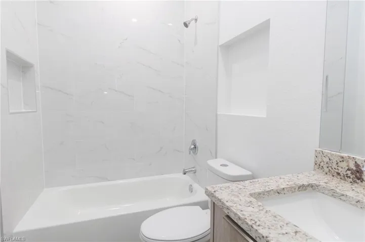 Full bath with vanity, toilet, and bathing tub / shower combination
