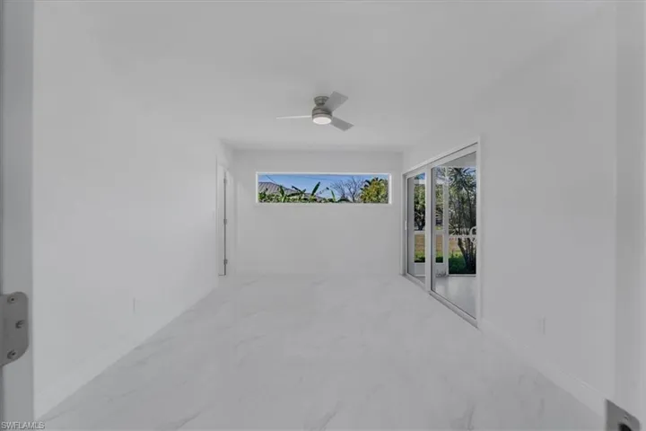 View of patio / terrace featuring a ceiling fan and a sunroom
