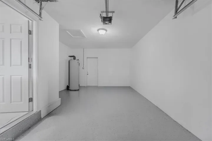 Garage with water heater and a garage door opener