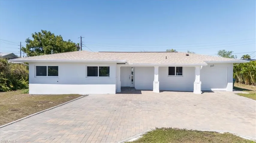 Ranch-style house with stucco siding, an attached garage, decorative driveway, and roof with shingles