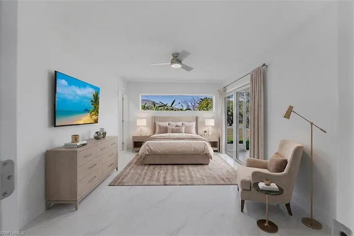 Bright interior featuring white tile flooring, a horizontal window, and a ceiling fan