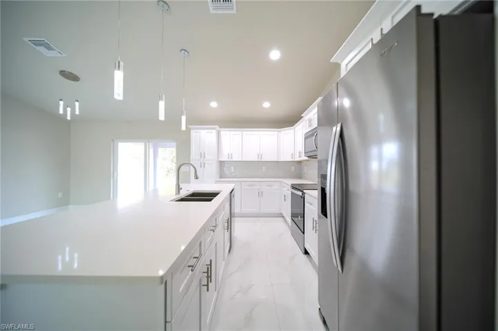 The Island Kitchen Comes With Quartz Countertops, Soft Touch White Wood Shaker Cabinets, Stainless Steel Appliances, Tile Backsplash, Floor To Ceiling Pantry, And Modern Lighting!