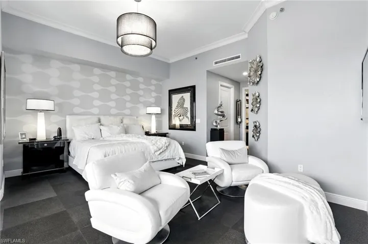 Bedroom with ornamental molding, wallpapered walls, and an accent wall - Virtually Edited Image