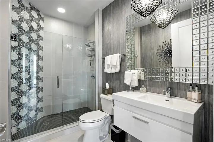 Full bath featuring vanity, a shower stall, and tile patterned flooring - Virtually Edited Image