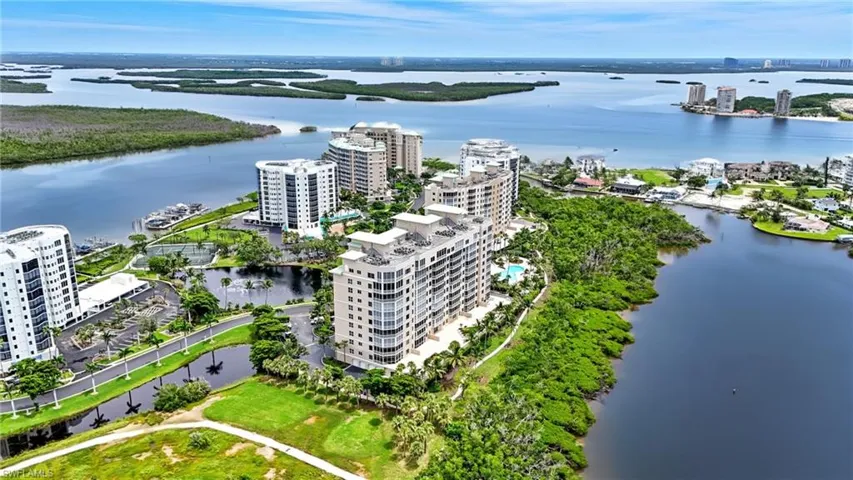 View of urban area with apartment complex / building and a large body of water - Virtually Edited Image
