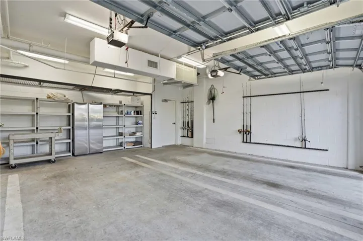 Garage with freestanding refrigerator and a garage door opener - Virtually Edited Image