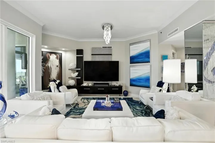 Living room featuring crown molding and plenty of natural light - Virtually Edited Image