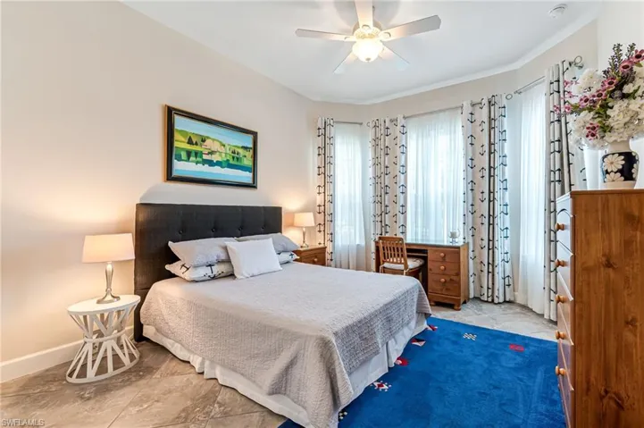 Bedroom with a ceiling fan and baseboards