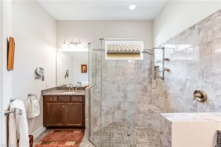Full bathroom featuring vanity and a stall shower