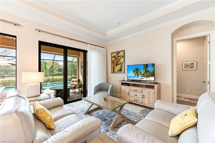 Living room with baseboards and crown molding