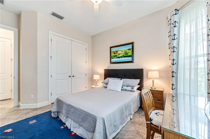 Bedroom with a closet, visible vents, baseboards, and ceiling fan