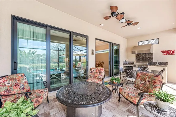 Balcony with exterior kitchen, a ceiling fan, a patio, and a grill