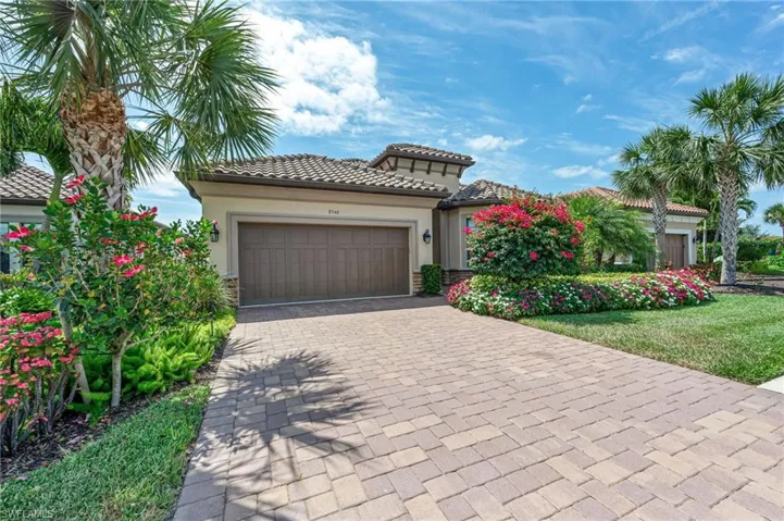 Mediterranean / spanish home with stucco siding, an attached garage, decorative driveway, and a tile roof