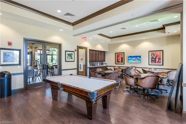 Game room with a raised ceiling, visible vents, crown molding, and french doors