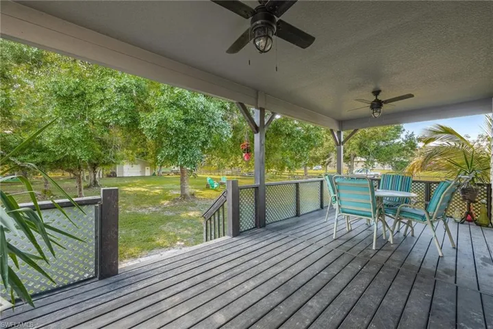 Large covered back porch overlooking the homestead. This Porch is accessed through French doors via main floor Primary Bedroom.