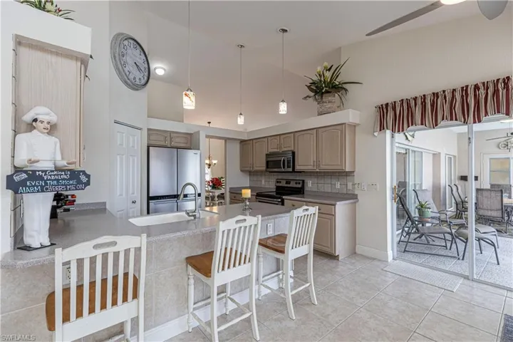 The kitchen stands out as the center of your entertainment with additional sliders to the lanai and pool.