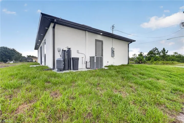 Contemporary exterior with white stucco finish, dark fascia, and black gutters