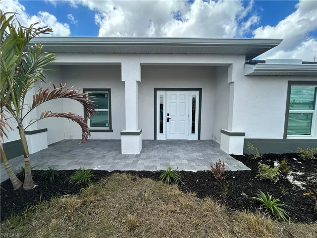 Doorway to property with stucco siding