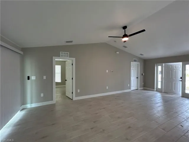 Unfurnished living room featuring a ceiling fan and light wood-type flooring